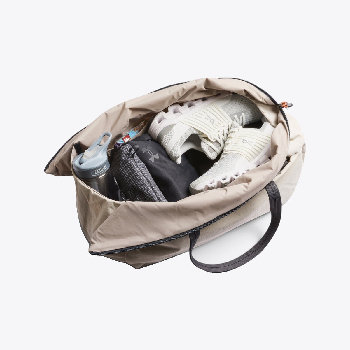 Sac de sport Bellroy beige ouvert avec chaussures et accessoires