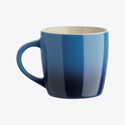 Blue ceramic cup with handle on the left, front view