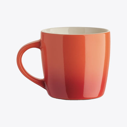 Orange ceramic cup with handle on the left, front view