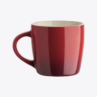 Red ceramic cup with handle on the left, front view