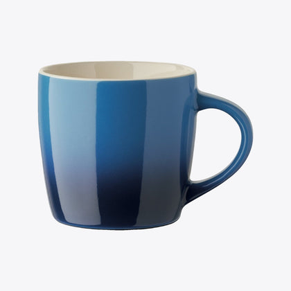 Blue ceramic cup with handle on the right, front view