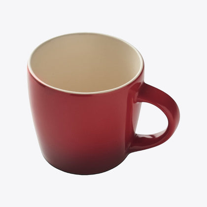 Red ceramic cup with cream interior, diving view