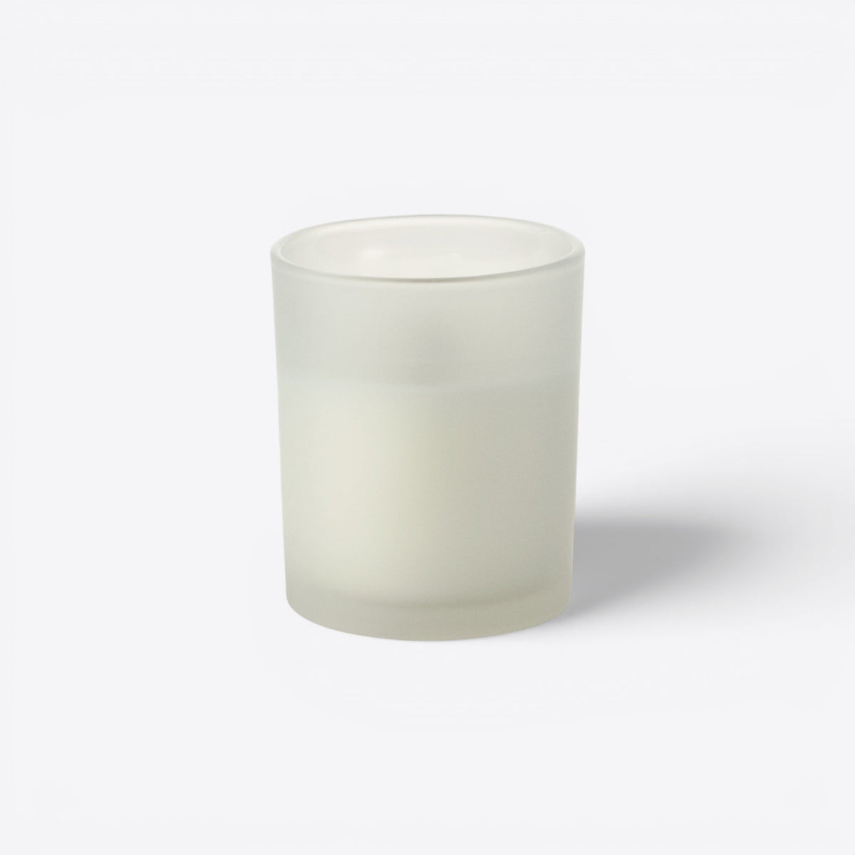 Bougie ronde dans un verre blanc dépoli, vue de face