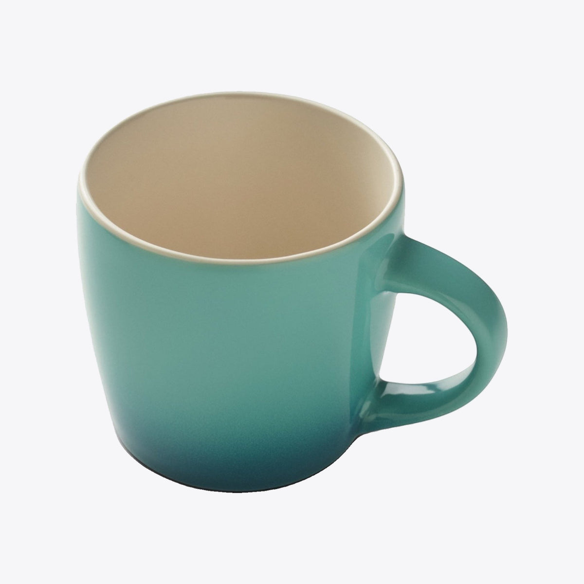 Tasse en céramique turquoise avec intérieur crème, vue plongeante